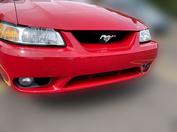 Front grille and running-horse badge